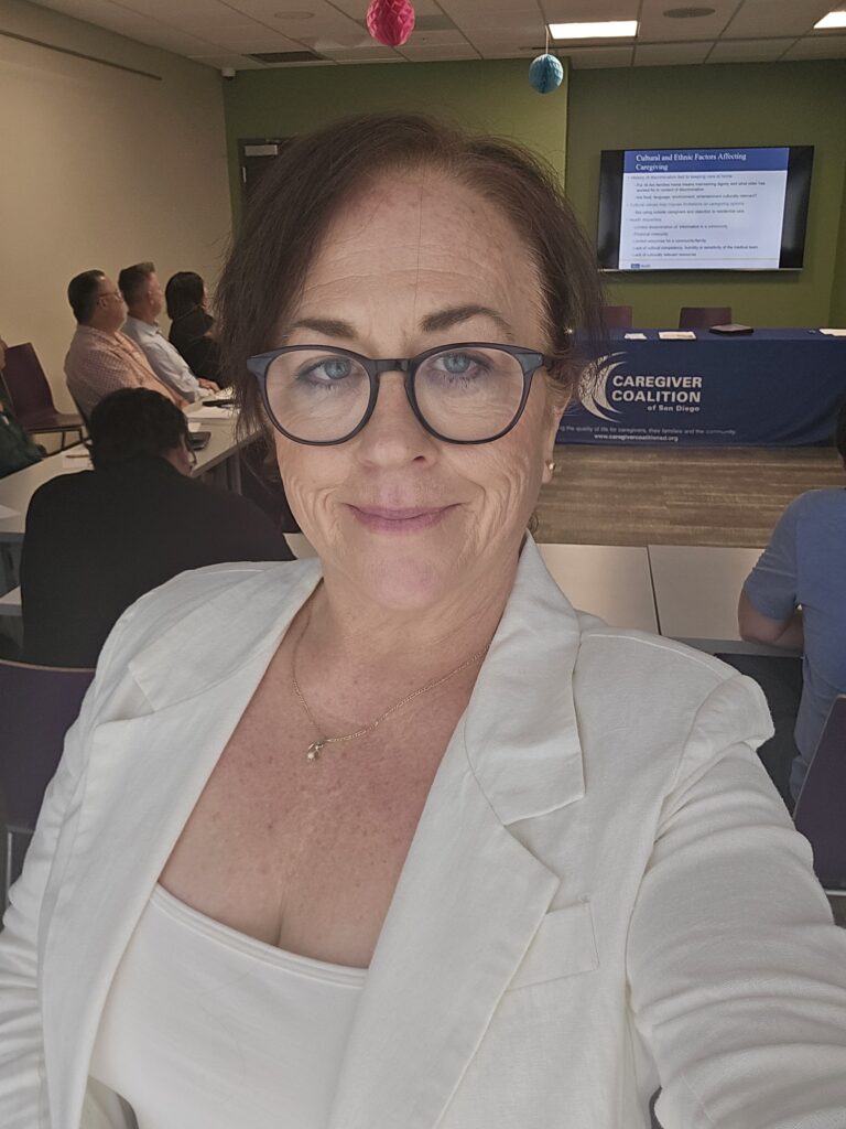 Veronica Mitchell taking a photo at a family caregiving talk