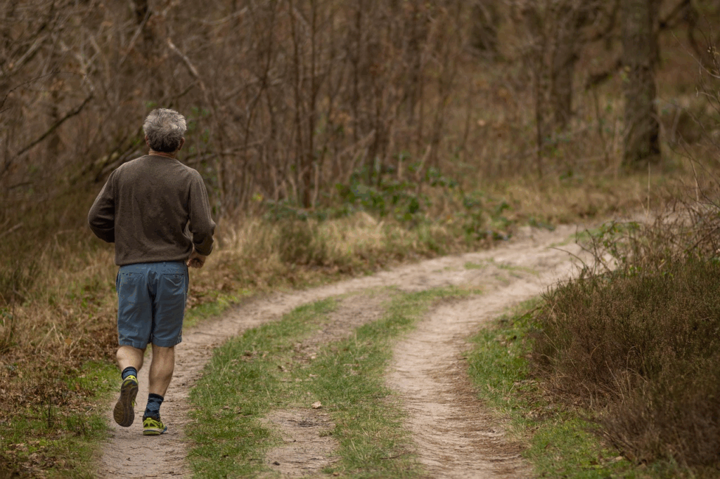 Older man jogging on trail for exercise